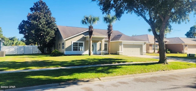 ranch-style house featuring a garage and a front lawn