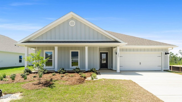 view of front of property featuring a garage and a front lawn