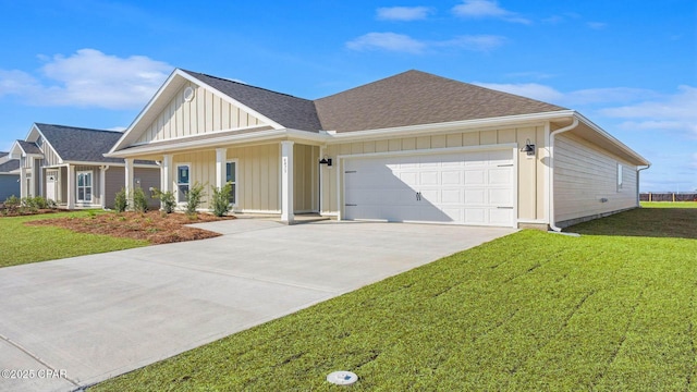 view of front of home with a porch, a garage, and a front yard