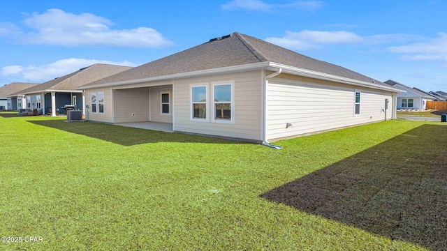 back of house with a patio, a yard, and central AC unit