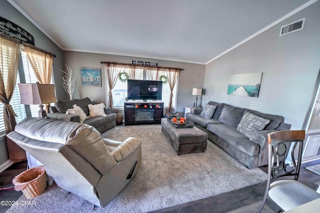 living room featuring vaulted ceiling and ornamental molding