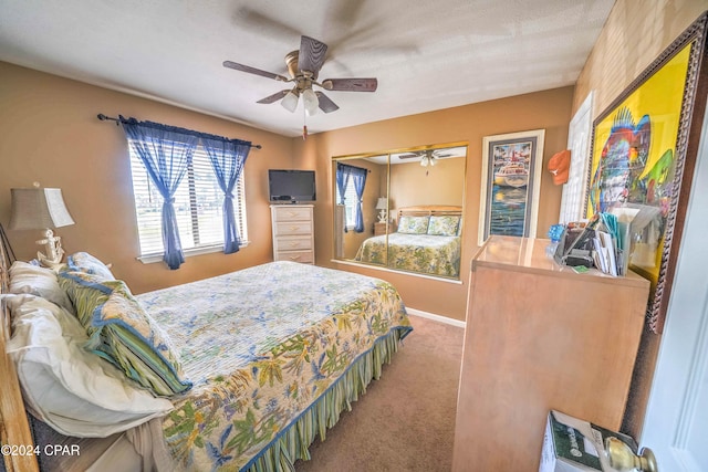 carpeted bedroom with ceiling fan, a textured ceiling, and a closet