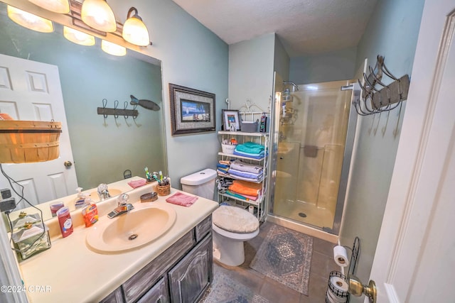 bathroom with vanity, a textured ceiling, toilet, and a shower with shower door