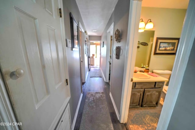 hall with dark wood-type flooring and sink