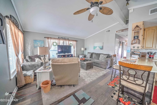 living room featuring lofted ceiling with beams, dark hardwood / wood-style floors, crown molding, and ceiling fan