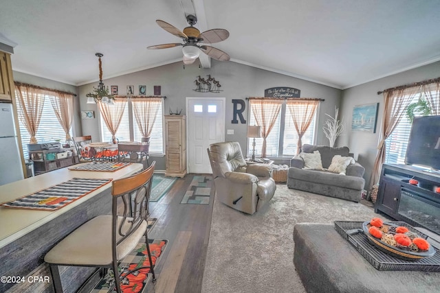 living room featuring lofted ceiling, ceiling fan, wood-type flooring, and ornamental molding