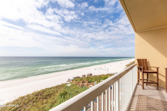 balcony with a water view and a beach view