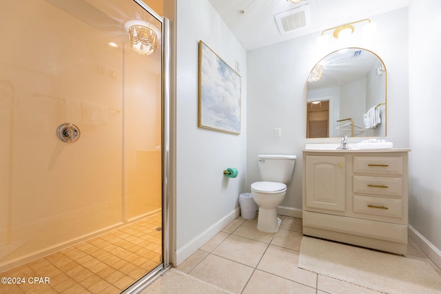 bathroom featuring toilet, vanity, tile patterned floors, and walk in shower