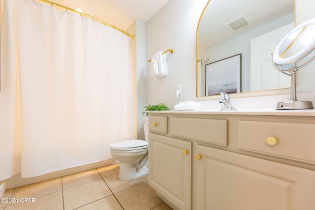 bathroom with tile patterned flooring, vanity, and toilet