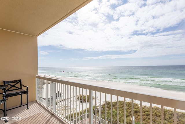 balcony featuring a water view and a view of the beach