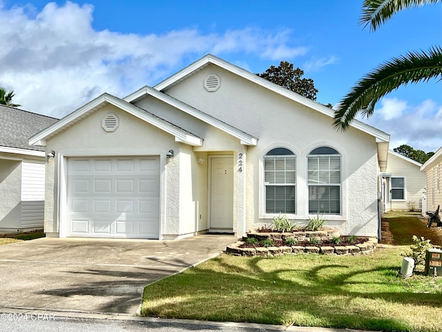 ranch-style home featuring a garage and a front lawn