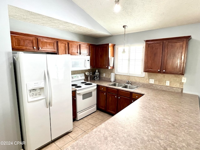 kitchen featuring sink, lofted ceiling, decorative light fixtures, white appliances, and light tile patterned flooring