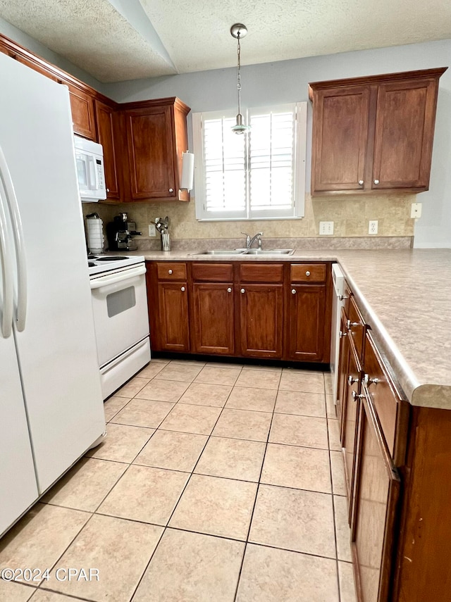 kitchen featuring sink, tasteful backsplash, decorative light fixtures, white appliances, and light tile patterned flooring