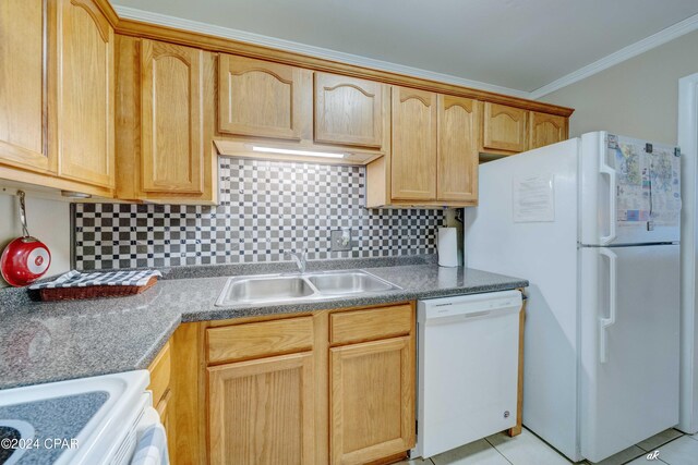 kitchen featuring ornamental molding, white appliances, a sink, and decorative backsplash