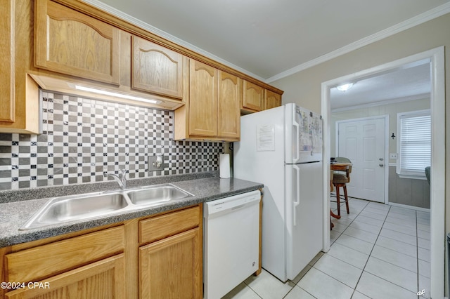 kitchen with light tile patterned floors, white appliances, a sink, tasteful backsplash, and crown molding