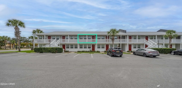 view of property featuring uncovered parking