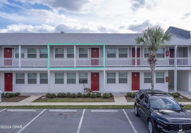 exterior space featuring uncovered parking and stucco siding