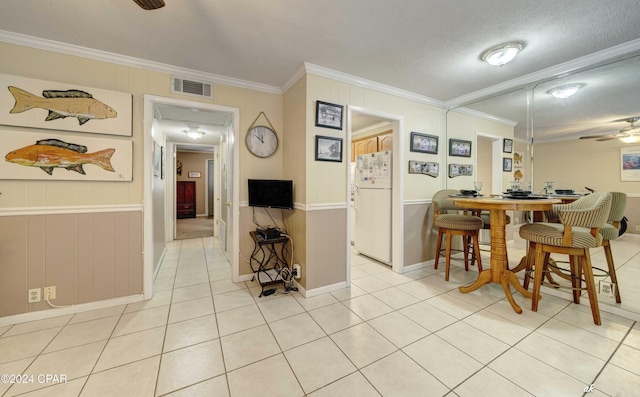 1301 Beck Ave Unit 16, Panama City, FL 32401 - dining space with baseboards, ornamental molding, light tile patterned flooring, visible vents, and ceiling fan