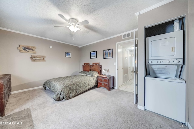 bedroom with a textured ceiling, stacked washer / dryer, visible vents, carpet, and crown molding