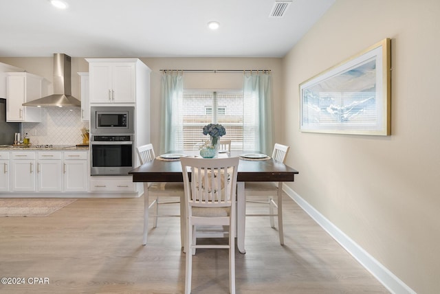 dining space featuring light hardwood / wood-style floors