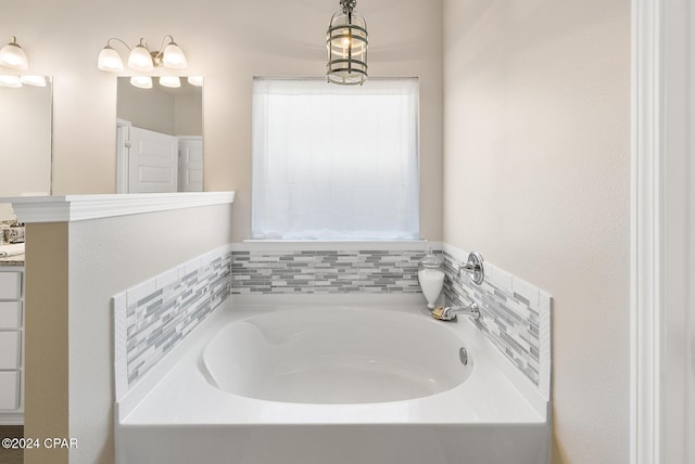 bathroom with vanity and a tub to relax in