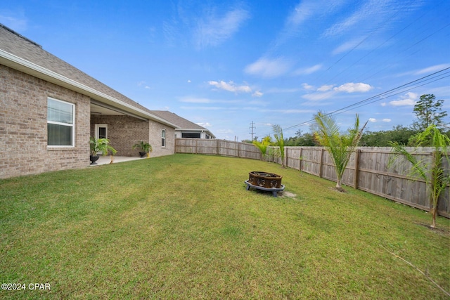 view of yard with a patio area and a fire pit