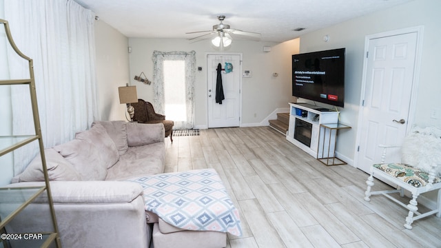 living room with ceiling fan and light hardwood / wood-style floors