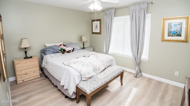 bedroom with light wood-type flooring and ceiling fan