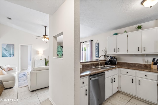 kitchen with sink, white cabinets, stainless steel dishwasher, and lofted ceiling