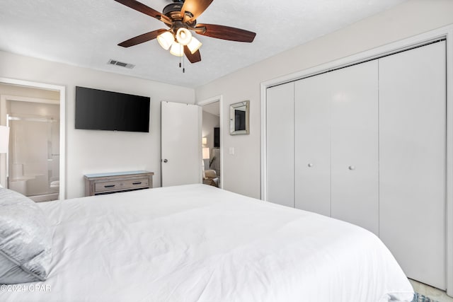 bedroom with ceiling fan, ensuite bathroom, a textured ceiling, and a closet