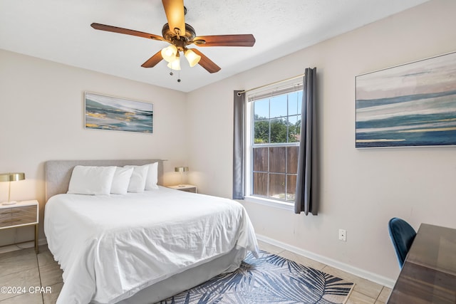 bedroom with ceiling fan and light tile patterned flooring