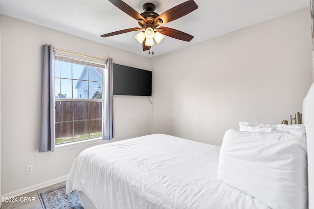 bedroom with ceiling fan and multiple windows