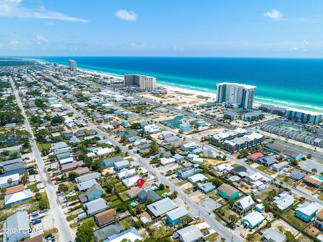 drone / aerial view with a water view and a beach view