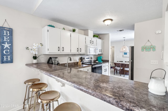 kitchen with kitchen peninsula, white cabinetry, hanging light fixtures, and stainless steel appliances