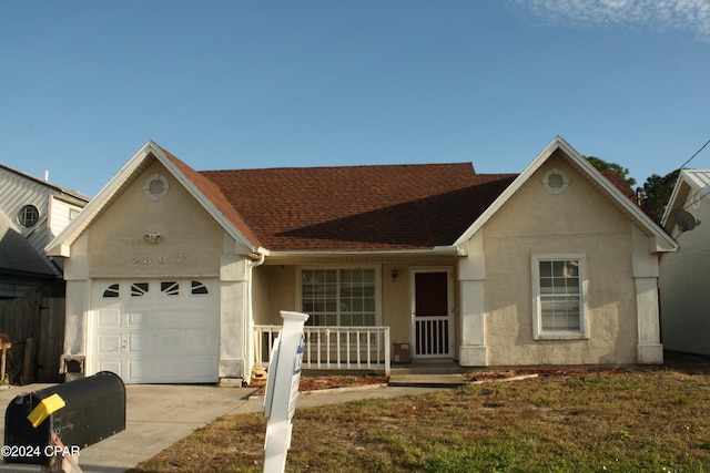 ranch-style house with covered porch and a garage