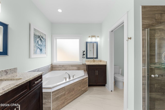 full bathroom featuring vanity, toilet, and separate shower and tub