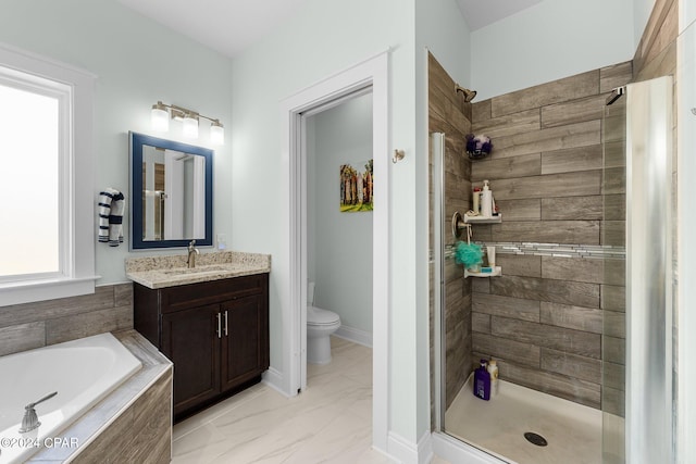 full bathroom featuring vanity, separate shower and tub, and toilet