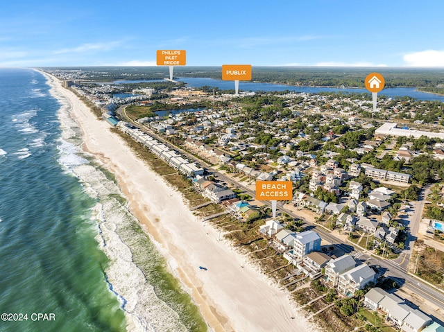 drone / aerial view featuring a view of the beach and a water view