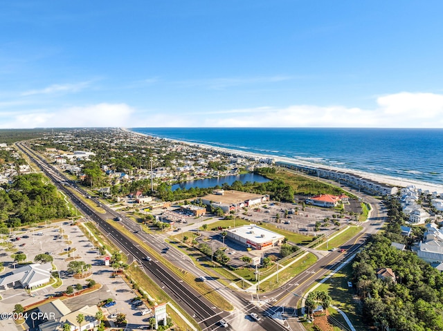 drone / aerial view featuring a water view and a beach view