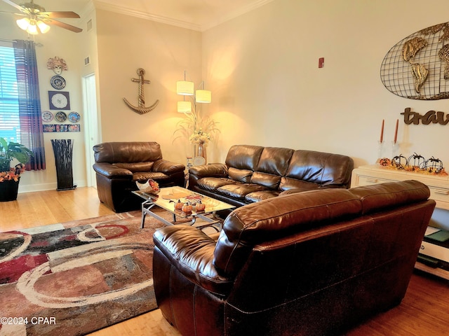 living room featuring wood-type flooring, ceiling fan, and crown molding