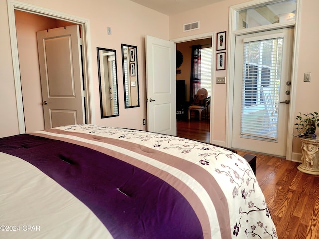 bedroom featuring access to outside and dark wood-type flooring