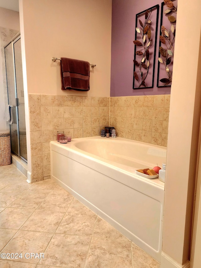 bathroom featuring tile patterned floors and separate shower and tub