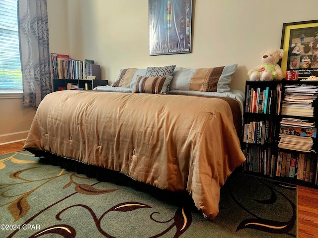 bedroom with wood-type flooring