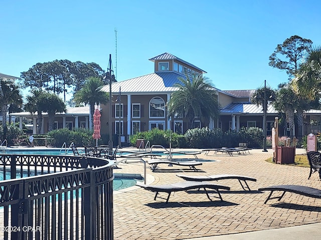 surrounding community featuring a pool and a patio area