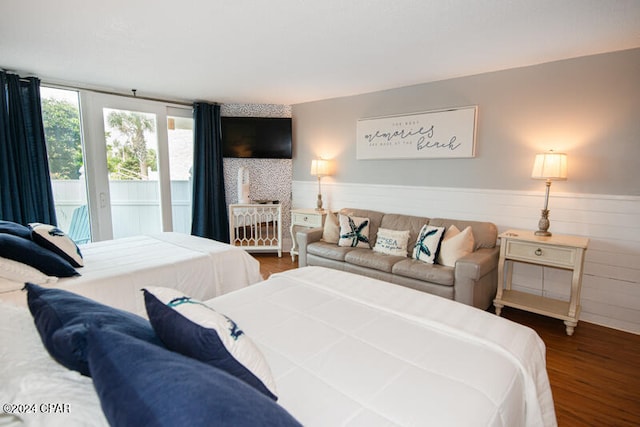 bedroom featuring wood-type flooring and access to outside