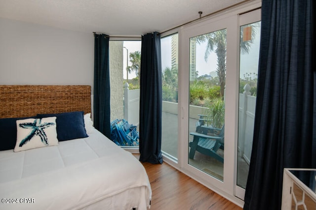 bedroom with wood-type flooring and a textured ceiling