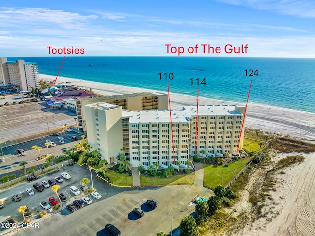 bird's eye view with a water view and a beach view