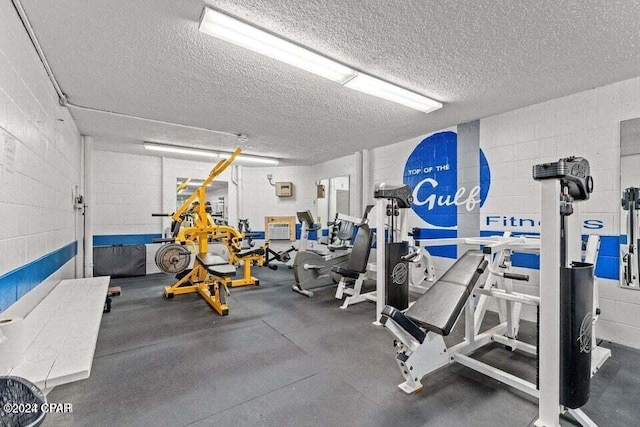 exercise room with a textured ceiling