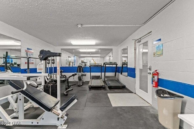 exercise room featuring a textured ceiling