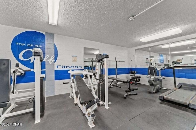 gym featuring a textured ceiling